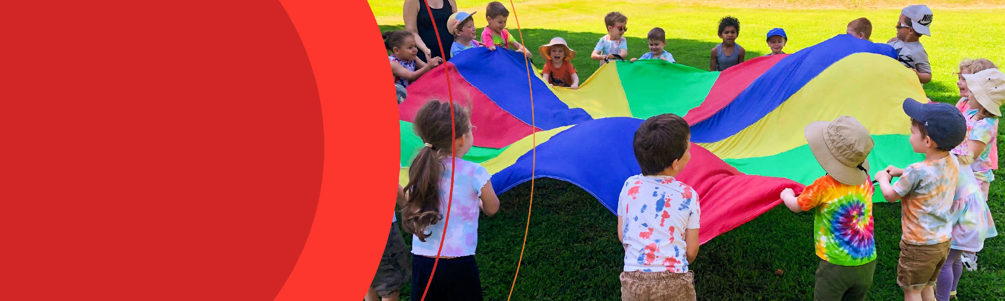 colorful picture of children playing with a parachute