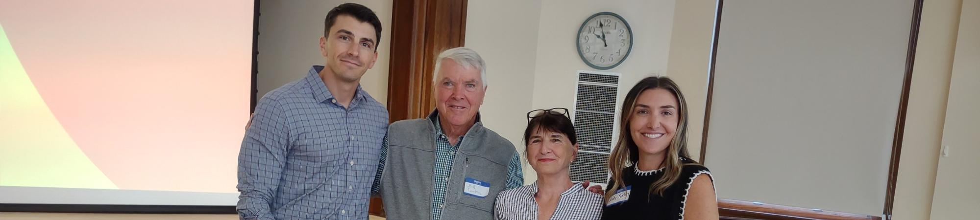 four people standing together