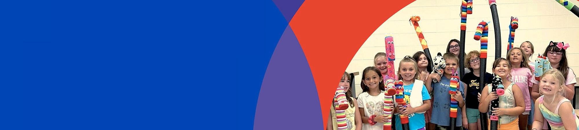 children cheering with artwork for giving tuesday